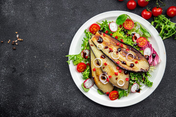 eggplant salad tomato, red pepper, green leaves fried vegetable snack on the table copy space food background rustic top view