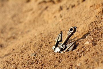 sea anchor stuck in a sand dune. without water close-up. the concept of shallowing and drought