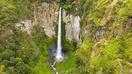 Fototapeta na wymiar Beautiful waterfall in the tropics. Sipiso Piso falls. Sumatra, Indonesia.