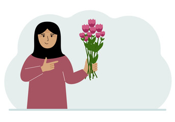 A arab woman is holding a large bouquet of flowers. The concept of a holiday, congratulations, romance or gift.