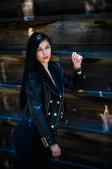 Grunge style, Beautiful sexy young woman with a dark long hair in leather jacket. Style of 90s