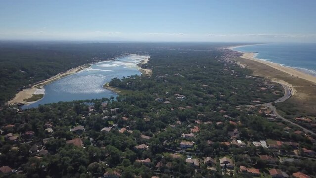 Aerial drone cinematic Hoosegor Capbreton France Bay of Biscay central beach over city town street cars roadway world surf league sunny mid day slowly forward movement