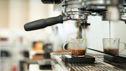 Coffee machine making espresso in coffee shop, shallow depth of field
