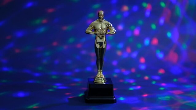 oscar gold statue trophy on a black background, symbol of the victory of the actor in his profession. editorial. Closeup Slow motion.