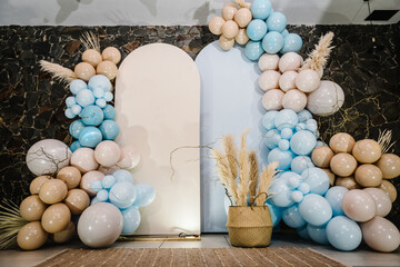 Arch on background balloons, party decor. Photo-wall decoration space or place with beige, brown and blue balloons. Celebration baptism concept. Birthday party. Trendy autumn decor. Wedding reception.