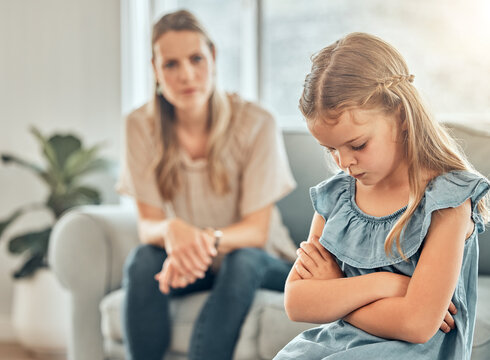 Angry mom, sad child and discipline in living room, frustration and problem with naughty girl behaviour in home. Scolding, punishment and frustrated mother, stubborn kid and communication with anger.
