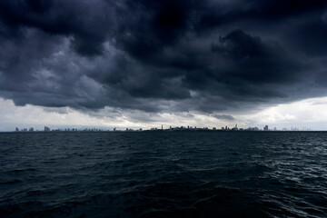 The city, the sea, and the dark clouds. it's going to rain