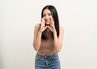 Happy beautiful asian woman with copy space. Excited pretty girl shout out loud wow with hands on...
