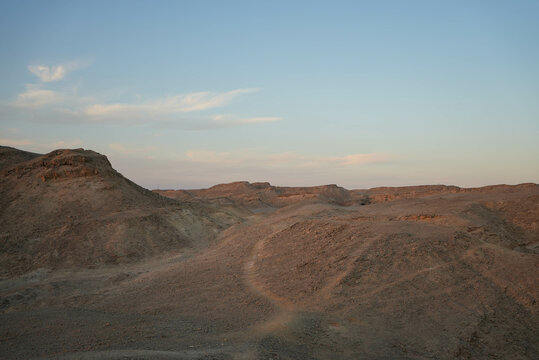 Desert landscape with hills and skyline in the evening at sunset