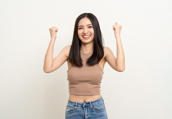 Obraz na płótnie Canvas Beautiful smiling happy young asian woman age around 25 in brown shirt. Charming female lady standing pose on isolated white background. Asian cute people looking camera confident with white backdrop.