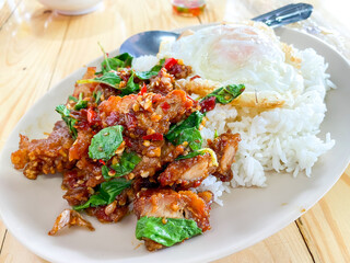 Rice topped with crispy pork belly with Thai basil and fried egg