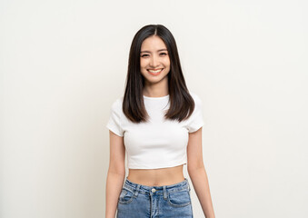 Beautiful smiling happy young asian woman age around 25 in white shirt. Charming female lady standing pose on isolated white background. Asian cute people looking camera confident with backdrop.