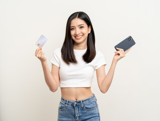 Portrait beautiful asian women standing pose holding credit card and smartphone to shopping payment. Attractive Happy businesswoman input the serial number of credit card cell phone financial