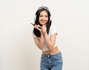 Beautiful young asian women choose song and play music from smartphone connection with wireless...