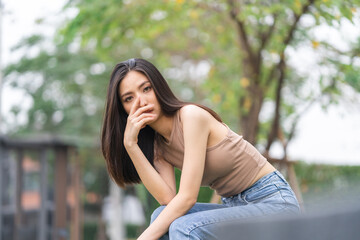 Naklejka premium Happy feeling of Beautiful Young Woman smiling outdoor in sunlight. Pretty attractive face of female and beautiful smile. She is positive thinking and successful.