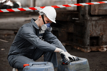 Industrial waste inspector examines the correct storage of hazardous chemicals, radioactive...
