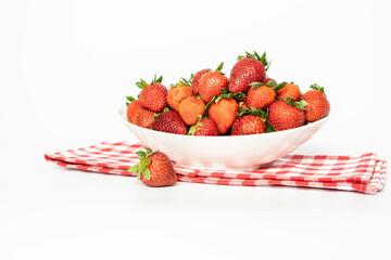 Strawberries in a white ceramic tray, on a white background. Eating healthy