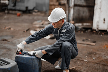 Industrial waste inspector examines the correct storage of hazardous chemicals, radioactive materials, toxic substances. Record field conditions on paperwork, collect data, and report to supervisor.