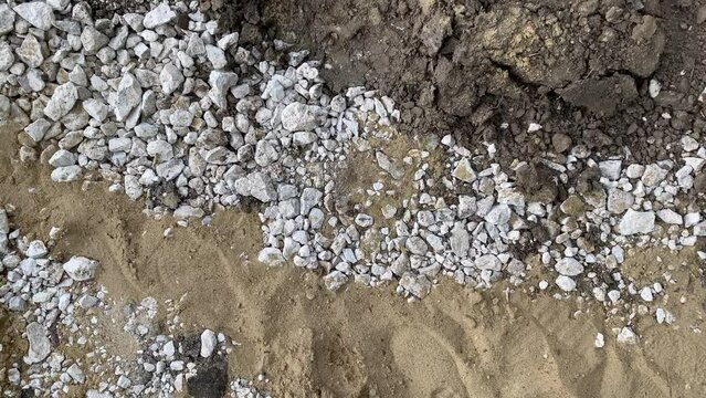 White gravel between sand and ground