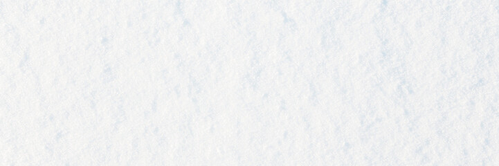 Fototapeta premium Natural snow texture. Smooth surface of clean fresh snow. Snowy ground. Wide panoramic winter background with snow patterns. Perfect for Christmas and New Year design. Closeup top view.