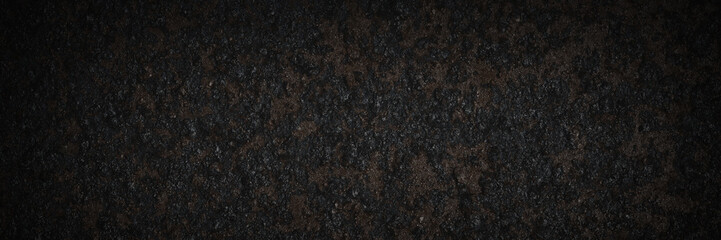 Old rusted metal texture. Rusty iron wall. Rough faded metal surface with spots, noise and grain. Dark wide panoramic background for grunge design. Shaded vintage texture with vignette.