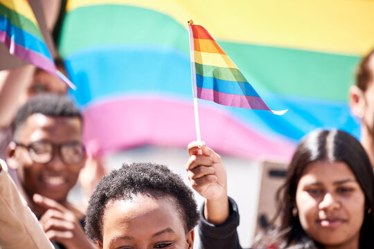 Pride, lgbtq and flag with people in protest for freedom, support and gay rally. Rainbow, society and community with crowd of protesters marching in city or equality, gender identity and celebration
