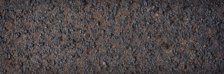 Texture of rusty metal. Rough metal surface with rust. Corroded and oxidized old iron. Rusted and aged metal sheet. Wide panoramic texture for background and design in grunge style.