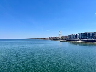 City sea coastline with promenade, blue sea and blue sky 