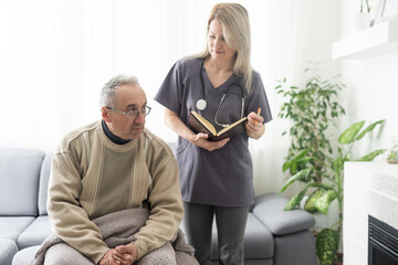 Picture of smiling nurse assisting senior man