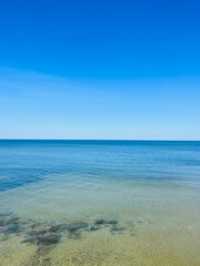 Fototapeta premium Blue transparent sea surface, blue sea horizon, clear blue sky