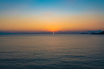 Fototapeta premium Brightly colored sunset over the calm Mediterranean Sea