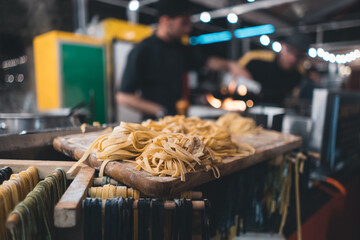 traditional italian black and yellow raw pasta on food festival