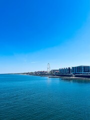 Naklejka na ściany i meble City sea coastline with promenade, blue sea and blue sky 