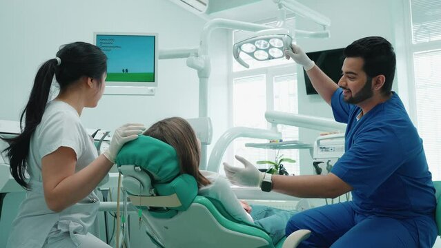 Friendly indian dentist man consults patient in hospital. Dentist appointment