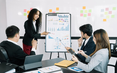 Asian businessman discuss with explaining a project, analyze planning and financial statistics and investment market at office.