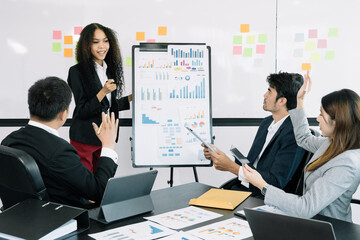 Asian businessman discuss with explaining a project, analyze planning and financial statistics and investment market at office.