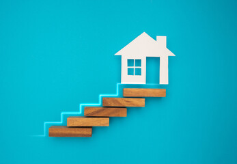 Property investment and house mortgage financial. Wooden blocks stacked steps to House.