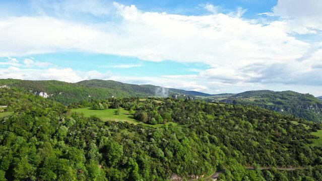 French countryside. Panoramic drone view of tree-covered hillsides of the heights of the Vercors, the marly hills and the valley Val de Drome, France