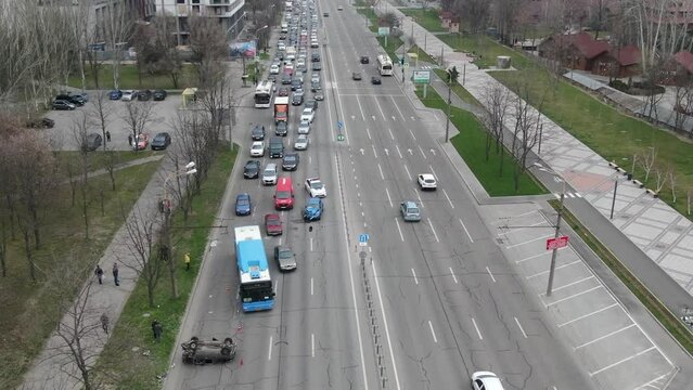 Strong accident in the city. Top view of traffic jam. Traffic accidents on the road. The light vehicle overturned after the impact.