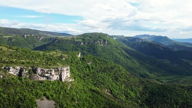 French countryside. Panoramic drone view of tree-covered hillsides of the heights of the Vercors, the marly hills and the valley Val de Drome, France