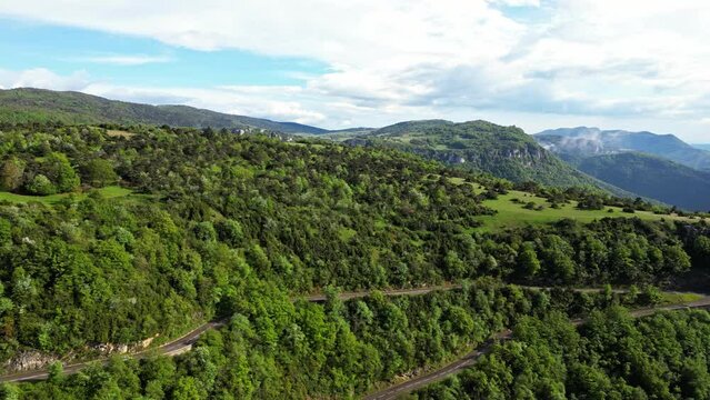 French countryside. Panoramic drone view of tree-covered hillsides of the heights of the Vercors, the marly hills and the valley Val de Drome, France