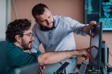 Programmers engrossed in deep collaboration, diligently working together to solve complex problems...