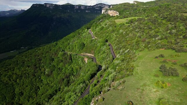 French countryside. Panoramic drone view of tree-covered hillsides of the heights of the Vercors, the marly hills and the valley Val de Drome, France