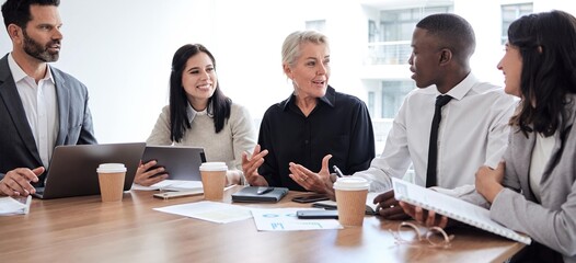 Business people, meeting and professional team talking in a corporate office for brainstorming. Diversity men and women at a table for planning, discussion and strategy with technology and ideas