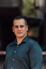 A portrait of a modern man, exuding confidence and style, against an outdoor backdrop, showcasing his charisma and fashionable demeanor.