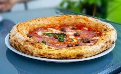 Pepperoni Pizza on Restaurant Plate, Salami Pizza with Olives, Tomatoes and Mozzarella Cheese