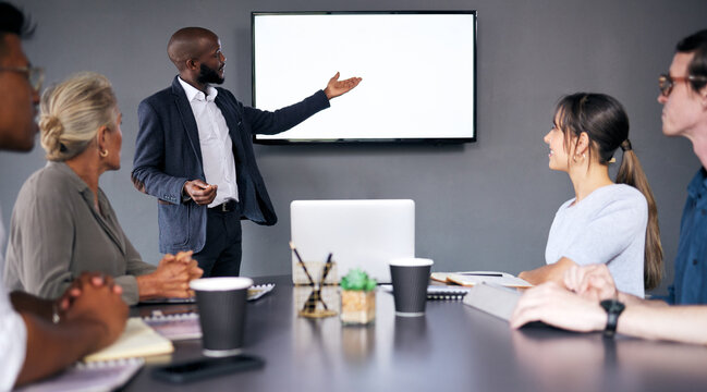 Businessman, coaching and meeting on mockup screen for project management or planning at the office. Black man, coach or business mentor in team presentation or training staff on mock up at workplace