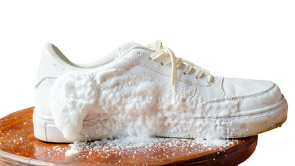 Cleansing foam on white leather footwear isolated on white background