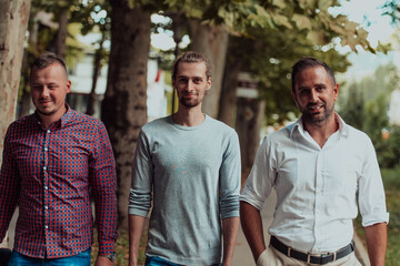 After a productive day at work, a group of diverse colleagues enjoy a leisurely stroll through a modern and natural urban setting