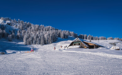 Fototapeta na wymiar Mountain ski resort Nassfeld in sunny winter day. Carinthia, Austria. January 2022